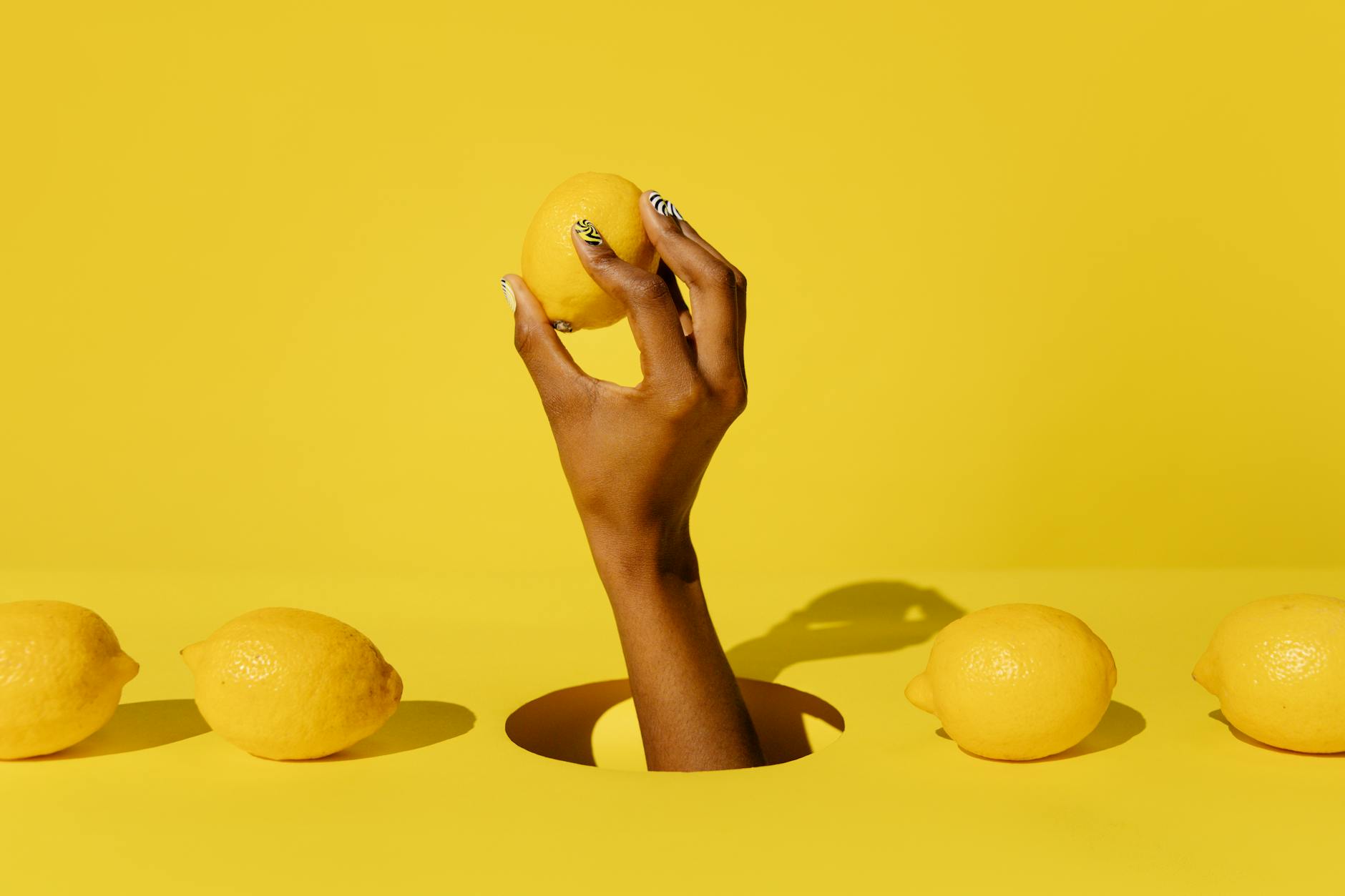 A collection of colorful clitoral vibrators arranged on a bright yellow background