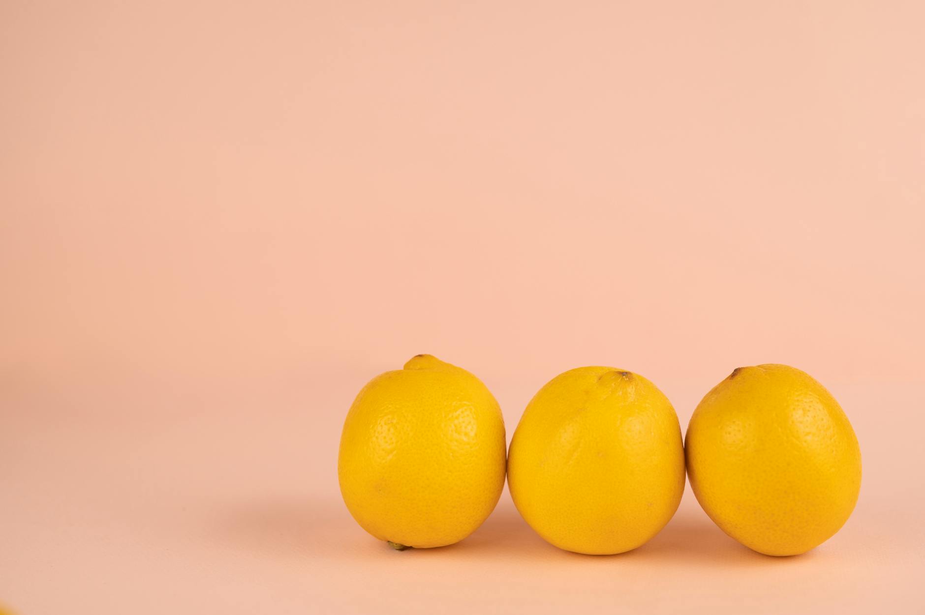Bright ripe lemons arranged on a soft pastel background, symbolizing renewal and fresh sensation